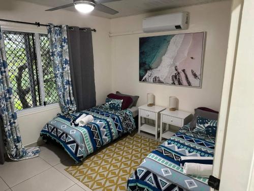 um quarto com duas camas e uma janela em Bamboo Villa em Port Vila