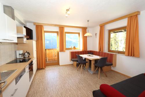 a kitchen and living room with a table and chairs at Ferienhaus Brandacher in Rohrberg