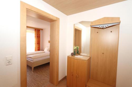 a room with a hallway with a door and a bedroom at Ferienhaus Brandacher in Rohrberg