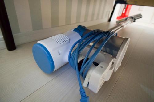 a blue and white appliance sitting on the floor at HANASTAY花渓居 · 楓（KAEDE) in Osaka