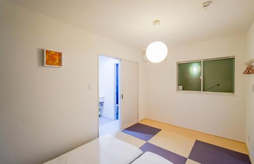 a living room with a checkered floor at HANASTAY花渓居 · 楓（KAEDE) in Osaka