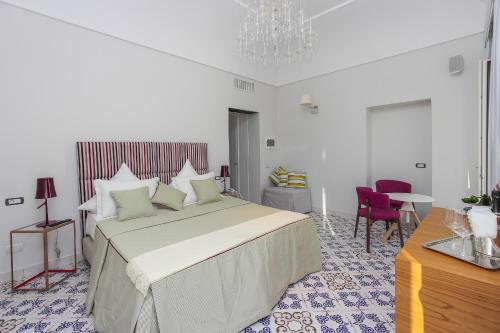 a bedroom with a large bed and a table and chairs at DieciSedici in Amalfi