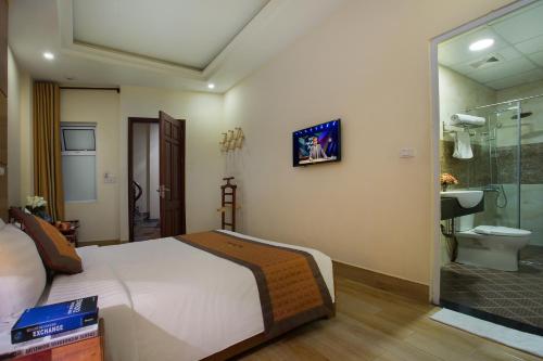 a bedroom with a bed and a bathroom with a shower at Vong Xua Boutique Hotel in Hanoi