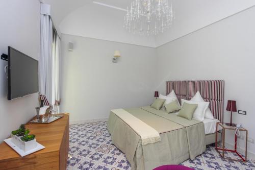 a bedroom with a bed and a flat screen tv at DieciSedici in Amalfi