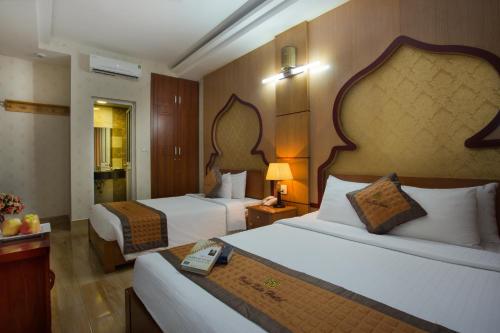 מיטה או מיטות בחדר ב-Vong Xua Boutique Hotel