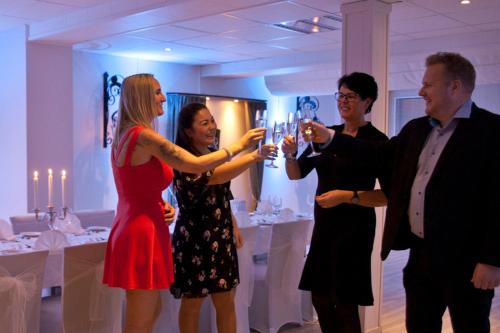 a man and a woman holding glasses of wine at Sølvgarden Hotel in Rysstad