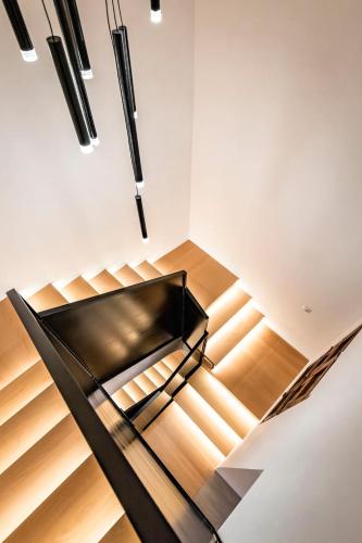 a staircase in a house with a black bench at ABBI Suites Casa Rural, Suites & Spa in Bocairent