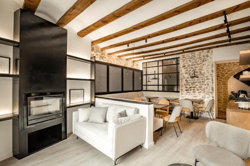 a living room with a white couch and a table at ABBI SUITES Casa Rural, Suites & Spa in Bocairent