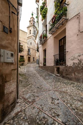 an alley in an old town with a clock tower at ABBI Suites Casa Rural, Suites & Spa in Bocairent