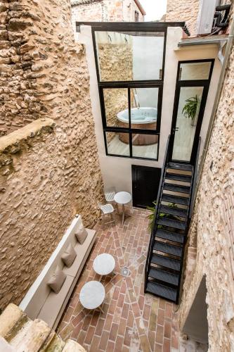 a building with two tables and a spiral staircase at ABBI Suites Casa Rural, Suites & Spa in Bocairent