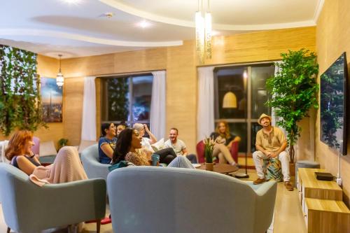 un grupo de personas sentadas en una sala de espera en HOMESTAR, Deluxe Hostel - JBR - Walk To Beach, Metro Station, en Dubái