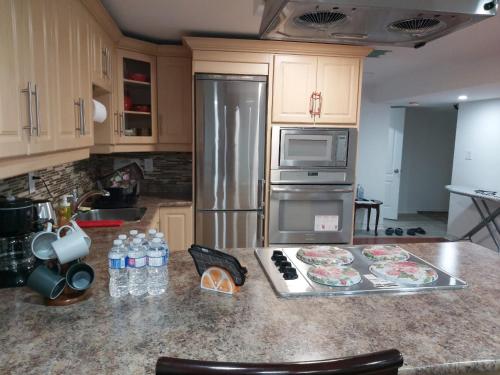 a kitchen with a stainless steel refrigerator and a counter at Guest House Room No 02 in Mississauga