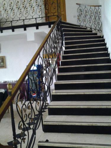 a staircase with black and white steps and a railing at Sophia Hotel in Dar es Salaam