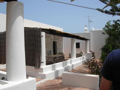 a white house with a porch and a building at Ca Balena piccola e grande in Stromboli
