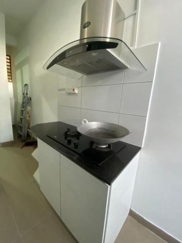 a kitchen counter with a sink and a hood at Airbnb Homestay P Residence in Kuching