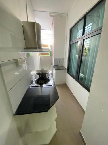 a kitchen with a black counter top in a room at Airbnb Homestay P Residence in Kuching
