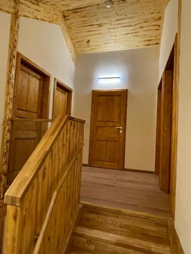 a hallway with wooden stairs and wooden doors at Hillside Chalet Kreischberg in Sankt Lorenzen ob Murau
