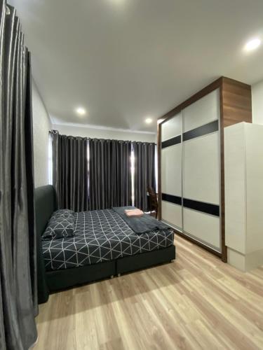 a bedroom with a bed and a large window at Airbnb Homestay P Residence in Kuching