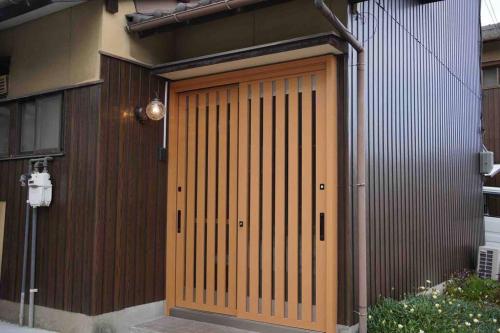 una puerta de garaje de madera en un edificio con en 吉田邸　古民家の落ち着いたお家, 