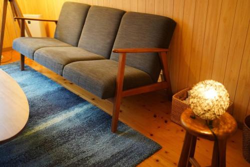 a living room with a couch and a table at 吉田邸　古民家の落ち着いたお家 in Ichimonji