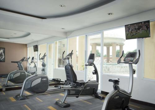 a gym with several treadmills and elliptical machines at BW Kemayoran Hotel & Convention Powered by Archipelago in Jakarta