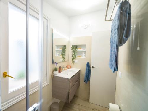 a bathroom with a sink and a mirror at Seafront Modern Villa to Relax and Disconnect in Cala en Bosc