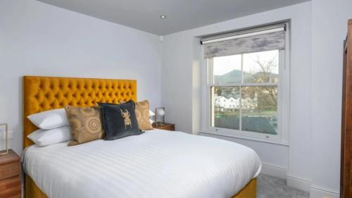 a bedroom with a large bed and a window at Keswick Lake Road Apartments in Keswick