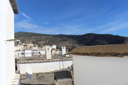 a view of a town with a mountain in the background at Casa Estrella de las nieves La Alpujarra in Bérchules