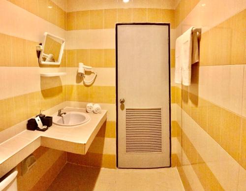 a bathroom with a sink and a shower at The Luka Guesthouse and Restaurant in Patong Beach
