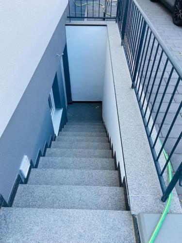 a staircase leading to a building with a white door at Practical Loft Comfort near Munich in Germering