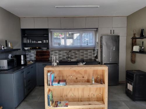 a kitchen with a wooden island in the middle at Cottages20 in Coffee Bay