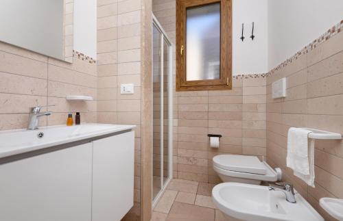 a bathroom with a sink and a toilet and a mirror at Marelive - CDSHotels in Torre dell'Orso