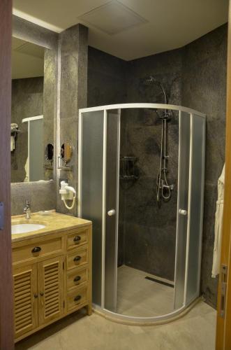 a bathroom with a shower and a sink at Shirvanshah Hotel in Baku