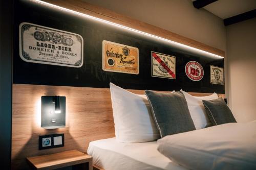 a bedroom with a bed and some stickers on the wall at Hotel Einbecker Hof in Einbeck