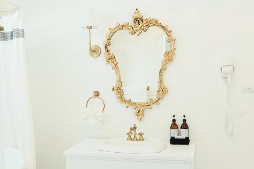 a bathroom with a mirror and a sink at La Villa de Adelina in Ensenada