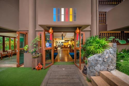a lobby of a building with green grass at Estia Chiangmai in Chiang Mai