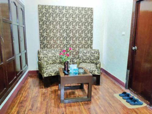 a living room with a couch and a table at Margalla View Motel in Islamabad