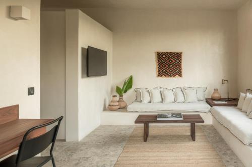 a living room with a couch and a table at Lindos Aqua Terra in Líndos