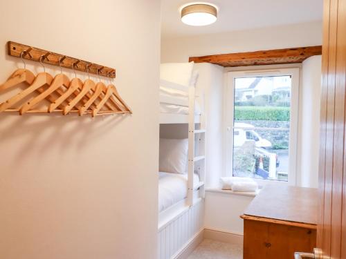 a room with a bunk bed and a window at Beach Road House in Ilfracombe