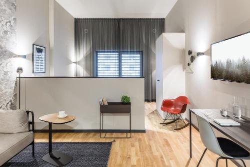 a living room with a couch and a table at ipartment Frankfurt Airport in Frankfurt/Main