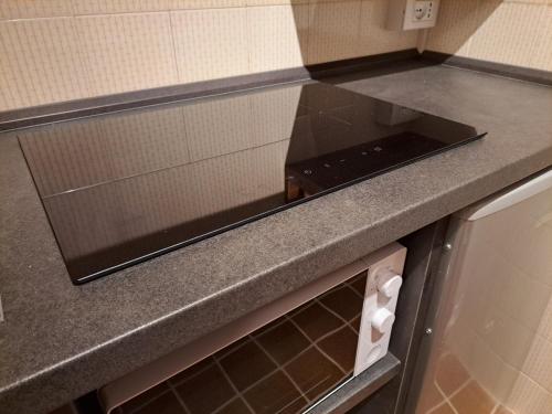 a kitchen with a counter top with a stove at MEADOWS Apartment in Ponte di Legno