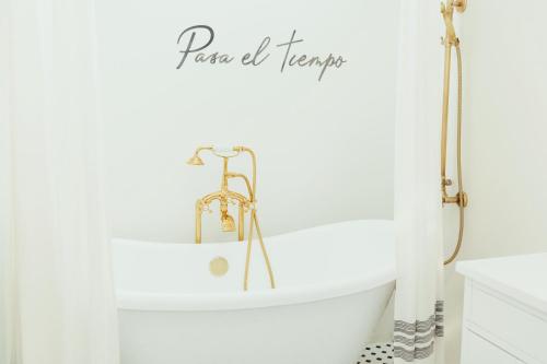 a bathroom with a white bath tub with a shower curtain at La Villa de Adelina in Ensenada