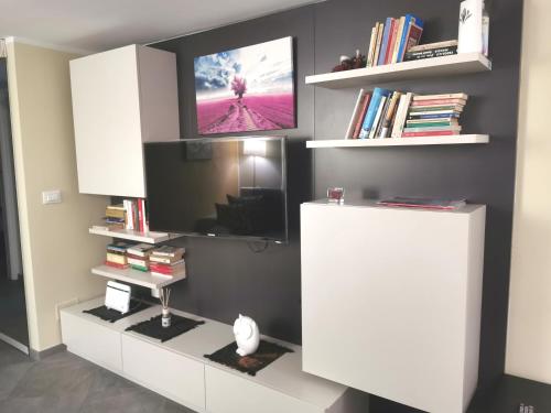 a living room with a tv on a wall at TORINO VACANCY 4 - Bridge House in Turin
