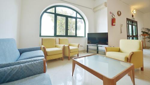 a living room with couches and a coffee table at Hotel Riviera in Procida