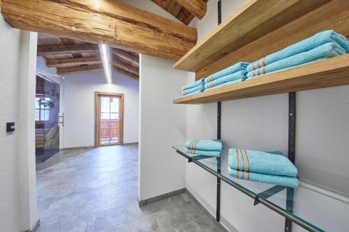 a room with wooden ceilings and shelves with towels at Almhütte Lengau in Saalbach-Hinterglemm
