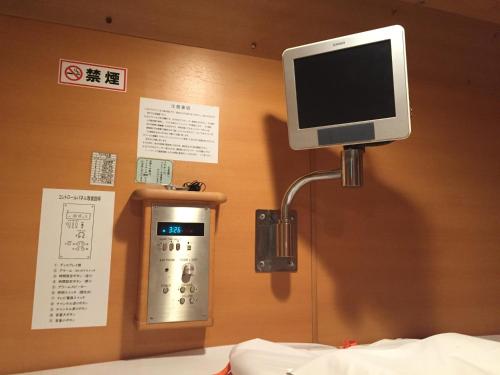 a television on a shelf in a room at Spa Resort President in Tokyo