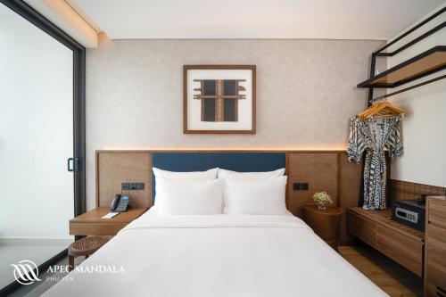 a bedroom with a large bed and a large window at Mandala Hotel & Spa Phú Yên - 24hours Stay in Tuy Hoa