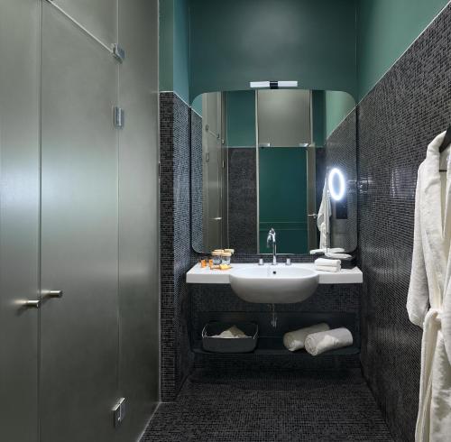 a bathroom with a sink and a mirror at Verno House Budapest, Vignette Collection by IHG in Budapest