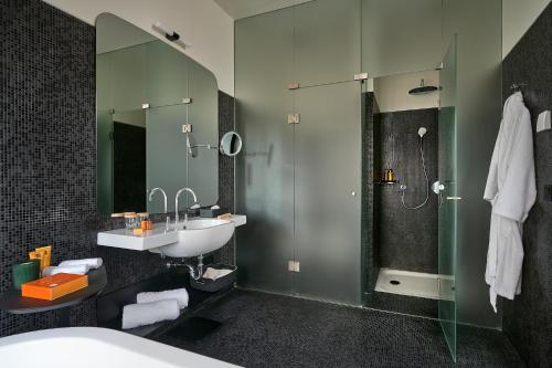 a bathroom with a sink and a shower at Verno House in Budapest