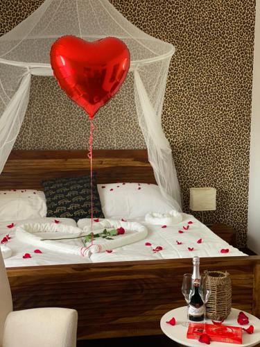 a heart balloon is attached to a bed at Malkia Penzion in Orechová Potôň
